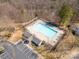 Aerial view of the neighborhood pool and clubhouse, surrounded by tall trees at 3209 Blythe Ridge Ct, Charlotte, NC 28213