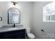 Clean bathroom featuring granite countertop, modern lighting, and fresh white walls at 324 Cabarrus W Ave, Concord, NC 28025