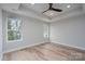 Bedroom with a tray ceiling, fan, and natural lighting at 324 Cabarrus W Ave, Concord, NC 28025