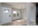 Welcoming entryway leading to a dining room with stylish chandelier at 324 Cabarrus W Ave, Concord, NC 28025