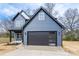 Charming two-story home with blue siding and a modern black garage door at 324 Cabarrus W Ave, Concord, NC 28025