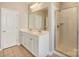 Bathroom features double sink vanity, large mirror, and glass enclosed shower at 3320 Tulip Tree Ln, Charlotte, NC 28273