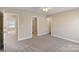 A carpeted bedroom with multiple entryways and a ceiling fan for comfort at 3320 Tulip Tree Ln, Charlotte, NC 28273