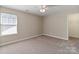 Neutral carpeted bedroom features a window at 3320 Tulip Tree Ln, Charlotte, NC 28273