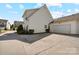 Exterior view showing garage, back of home, and landscaped yard at 3320 Tulip Tree Ln, Charlotte, NC 28273