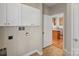 Functional laundry room with storage cabinets, and open access to the kitchen at 3320 Tulip Tree Ln, Charlotte, NC 28273