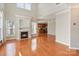 Bright living room featuring a fireplace, hardwood floors, and open layout with kitchen view at 3320 Tulip Tree Ln, Charlotte, NC 28273