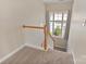 A carpeted stairway landing featuring a window that provides plenty of natural light at 3320 Tulip Tree Ln, Charlotte, NC 28273