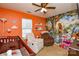 Vibrant Bedroom adorned with playful wallpaper, comfortable seating, and a cozy crib at 3345 Hunting Wood Ct, Gastonia, NC 28052