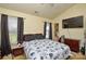 Bedroom with two windows, a bed with a black and white floral comforter, and a television at 3345 Hunting Wood Ct, Gastonia, NC 28052