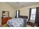 Bedroom with two windows, a bed with a black and white floral comforter, and dresser at 3345 Hunting Wood Ct, Gastonia, NC 28052