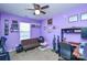 Stylish bedroom with lilac walls, a ceiling fan, and a cozy sitting area at 3345 Hunting Wood Ct, Gastonia, NC 28052