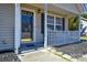 A cozy front porch with a bench, black mulch and a dark front door at 3345 Hunting Wood Ct, Gastonia, NC 28052