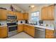 Modern kitchen with stainless steel appliances, bright countertops, and plenty of cabinet storage at 3345 Hunting Wood Ct, Gastonia, NC 28052