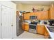 Well-equipped kitchen featuring stainless steel appliances, light wood cabinetry, and ample counter space at 3345 Hunting Wood Ct, Gastonia, NC 28052