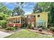 Backyard view of the home with a brick base, screen room, and a patio area featuring an umbrella at 3615 Henshaw Rd, Charlotte, NC 28209