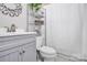 Bathroom featuring gray vanity and shelving unit at 3615 Henshaw Rd, Charlotte, NC 28209