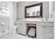 Modern bathroom with double vanity, decorative mirror, and ample storage at 3615 Henshaw Rd, Charlotte, NC 28209