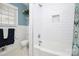 Bright bathroom with white tile, a bathtub and shower, and window for natural light at 3615 Henshaw Rd, Charlotte, NC 28209