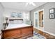 Stylish bedroom featuring a wood bed frame, soft textures, and ensuite bathroom at 3615 Henshaw Rd, Charlotte, NC 28209