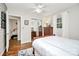 Bright bedroom with hardwood floors, dresser, and neutral décor at 3615 Henshaw Rd, Charlotte, NC 28209