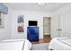 Bright bedroom featuring two twin beds, beach-themed art, blue dresser, and hardwood flooring at 3615 Henshaw Rd, Charlotte, NC 28209