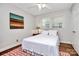 Cozy bedroom with a comfortable bed, natural light from the window, and hardwood flooring at 3615 Henshaw Rd, Charlotte, NC 28209