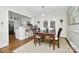 Dining area adjacent to the kitchen with a traditional table, chairs, and views of the backyard through French doors at 3615 Henshaw Rd, Charlotte, NC 28209