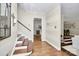 Elegant foyer with hardwood floors, striped walls, stairway, and views into the kitchen and living room at 3615 Henshaw Rd, Charlotte, NC 28209