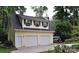 Detached garage with two bays, yellow siding, green shutters, and boat parking at 3615 Henshaw Rd, Charlotte, NC 28209