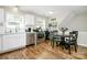 Bright eat-in kitchen with hardwood floors, stainless steel appliances, and white cabinets at 3615 Henshaw Rd, Charlotte, NC 28209