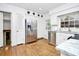 Kitchen featuring stainless steel appliances, white cabinets, hardwood floors, and a bright window above the sink at 3615 Henshaw Rd, Charlotte, NC 28209