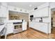 Bright white kitchen featuring stainless steel appliances, granite countertops, and hardwood flooring at 3615 Henshaw Rd, Charlotte, NC 28209