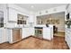 Charming kitchen with white cabinetry, stainless steel appliances, hardwood floors, and an open layout to the dining room at 3615 Henshaw Rd, Charlotte, NC 28209