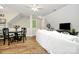 Open living area featuring a white sofa, hardwood floors, and dining table at 3615 Henshaw Rd, Charlotte, NC 28209