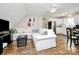 Bright living room featuring a modern white sectional sofa and hardwood floors at 3615 Henshaw Rd, Charlotte, NC 28209