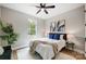 Bedroom featuring wood floors, natural light, a ceiling fan, and minimalist decor at 388 Speedway Nw Pl # 1, Concord, NC 28027