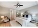 Comfortable bedroom featuring a ceiling fan, natural light, and stylish decor at 388 Speedway Nw Pl # 1, Concord, NC 28027