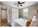 Cozy bedroom with light gray walls, a ceiling fan, a window, and a closet at 388 Speedway Nw Pl # 1, Concord, NC 28027