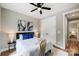 Light-filled bedroom with a ceiling fan, white closet doors, and wood flooring at 388 Speedway Nw Pl # 1, Concord, NC 28027