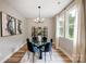 Cozy dining room with modern chandelier, large windows, and an accent wall with art at 388 Speedway Nw Pl # 1, Concord, NC 28027