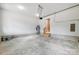 Bright, empty garage space with visible water heater and access stairs at 388 Speedway Nw Pl # 1, Concord, NC 28027