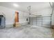 Clean garage with concrete floors, white walls, and an electric garage door opener at 388 Speedway Nw Pl # 1, Concord, NC 28027