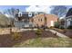 Brick home with a large outdoor space for entertaining with a patio, deck, and fire pit at 4000 Bridgewood Ln, Charlotte, NC 28226