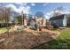 Spacious backyard featuring a deck, garden area, and mature trees at 4000 Bridgewood Ln, Charlotte, NC 28226