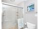 Tiled bathroom featuring glass enclosed shower with decoratively-patterned accent towels at 4000 Bridgewood Ln, Charlotte, NC 28226