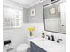 Stylish bathroom with white wainscoting, marble countertop, and modern fixtures at 4000 Bridgewood Ln, Charlotte, NC 28226