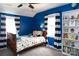 bedroom features a blue color scheme, decorative bedding and striped curtains at 4000 Bridgewood Ln, Charlotte, NC 28226