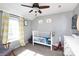 Neutral Bedroom featuring wood-look ceiling fan, chair and white dresser at 4000 Bridgewood Ln, Charlotte, NC 28226