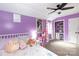 Purple bedroom features posters, a ceiling fan, and a doll house at 4000 Bridgewood Ln, Charlotte, NC 28226